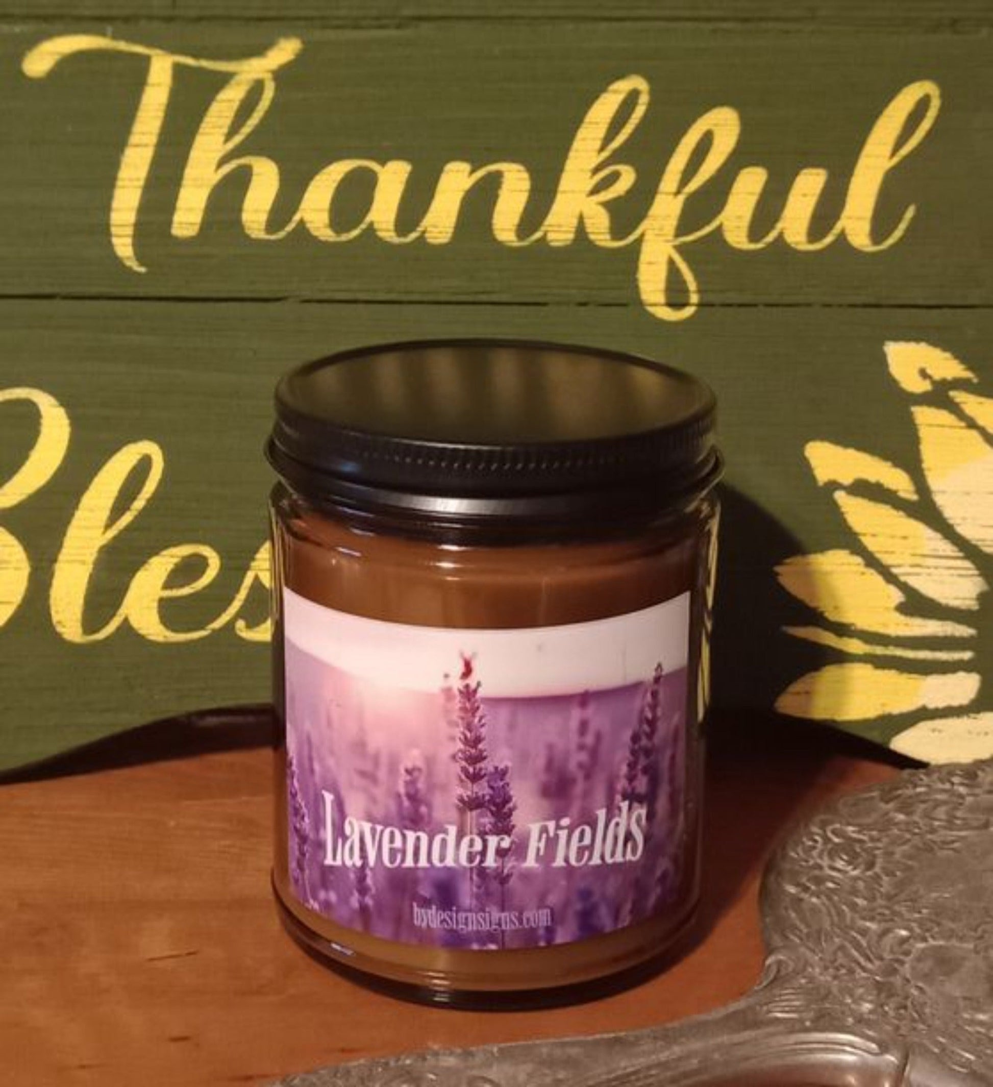 Image of a 9oz Dark Glass Jar Wood Wick Scented Candle with the image of Lavender Fields and the words Lavender Fields written on it.